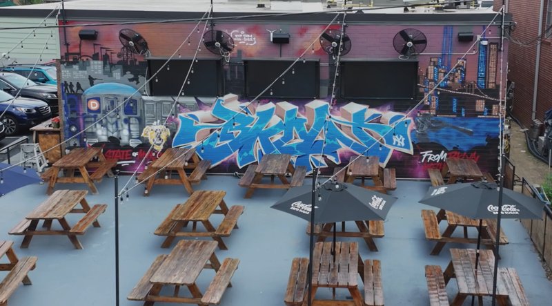 Outdoor seating area with mural in Cary, North Carolina.