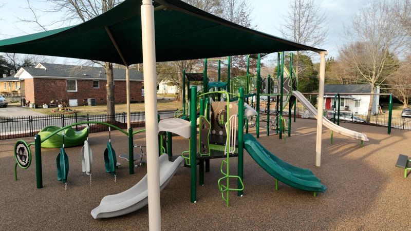Children’s playground with slides and shade canopy in Clayton neighborhood park