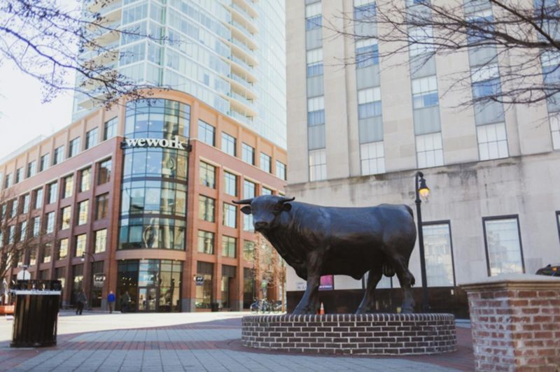 Major the Bull statue in downtown Durham NC with modern buildings backdrop