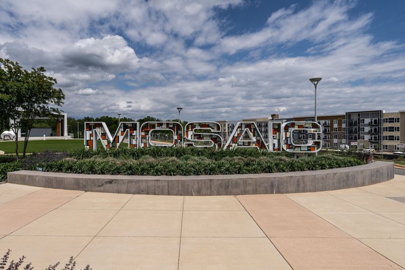 Mosaic development signage in Pittsboro, North Carolina with modern design and landscaping