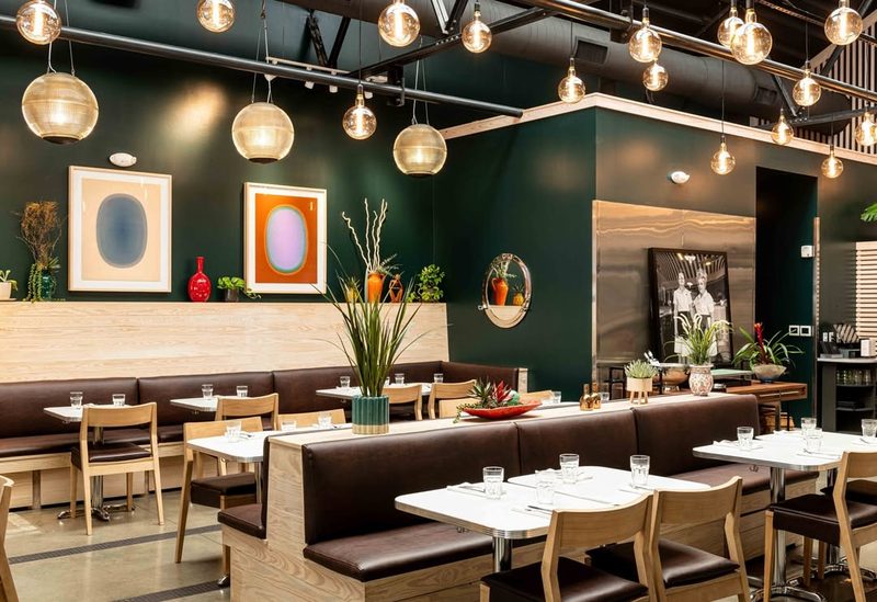 Interior dining room of Poole's Diner with modern decor and booth seating in Raleigh, North Carolina.