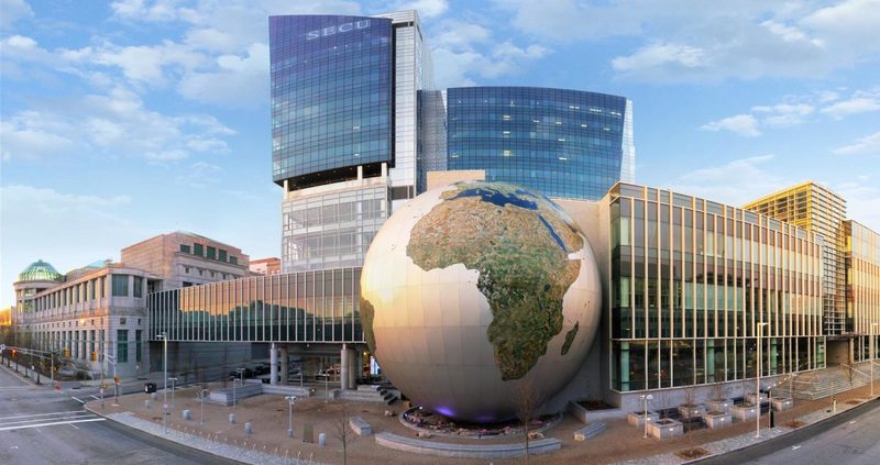 North Carolina Museum of Natural Sciences globe exhibit in downtown Raleigh, North Carolina with surrounding modern architecture.