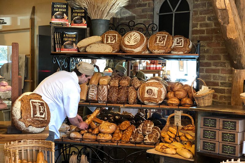 Interior of La Farm Bakery with artisan breads on display in Raleigh, North Carolina.