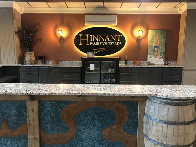 Interior tasting bar at Hinnant Family Vineyards with signage and wine display in Selma, North Carolina.