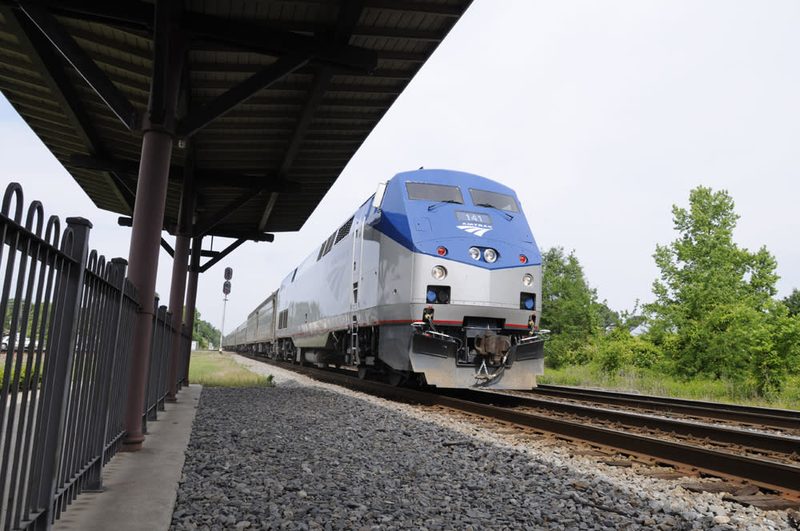 Amtrak train arriving at a station platform in Selma, North Carolina.